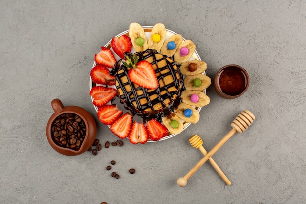 top view pancakes along with fresh fruits and chocolate on the grey floor