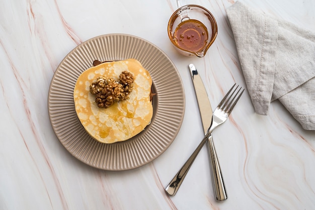 Top view pancakes with honey on the table