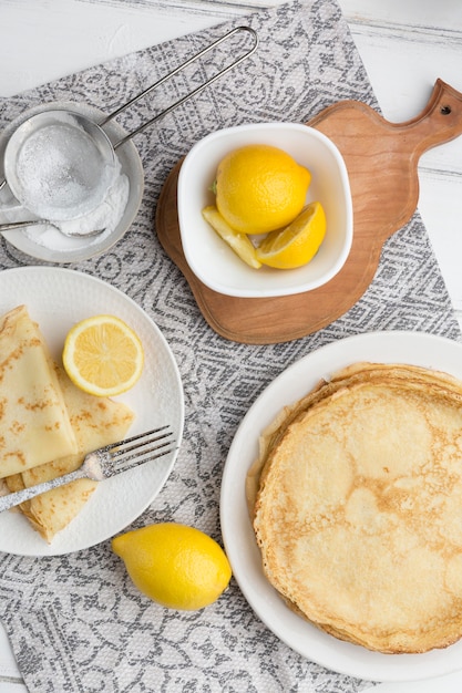 Free photo top view pancakes with lemons