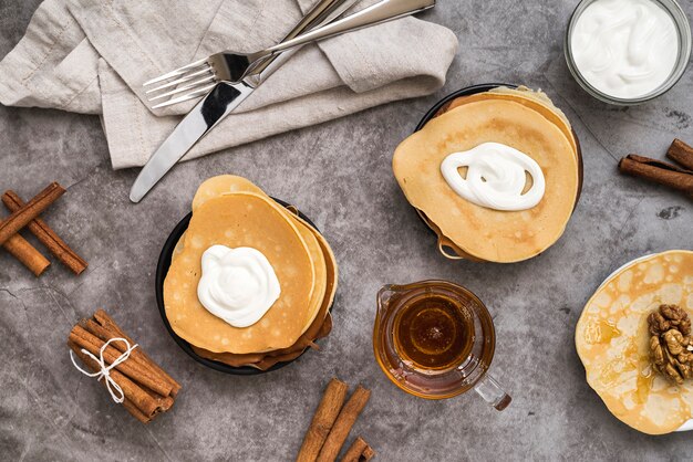 Top view pancakes with maple syrup on the table