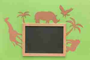 Free photo top view of paper animals with blackboard for animal day