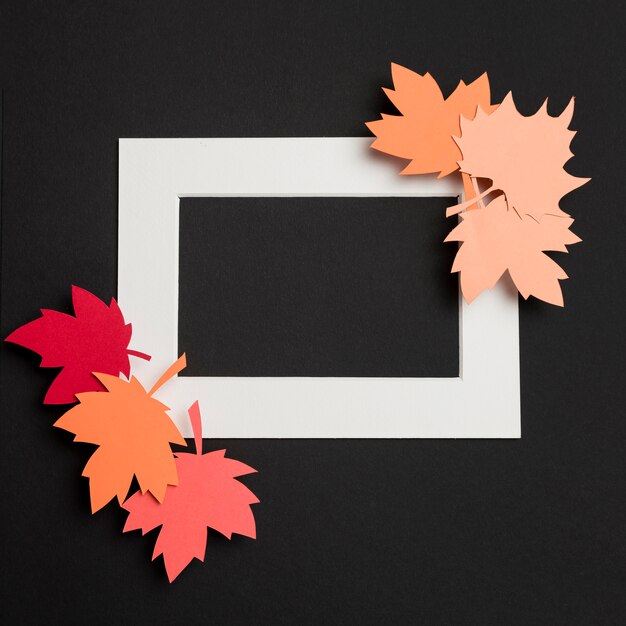 Top view paper autumn leaves composition on white frame