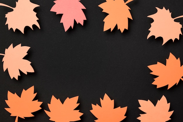 Top view paper autumn leaves composition with copy space