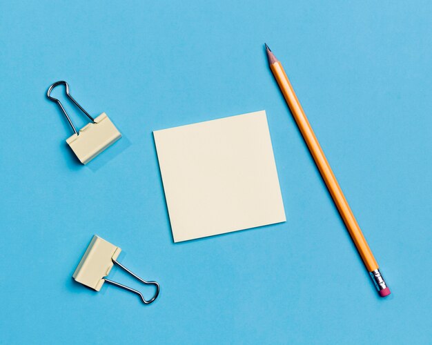 Top view paper clips and pencil on the desk