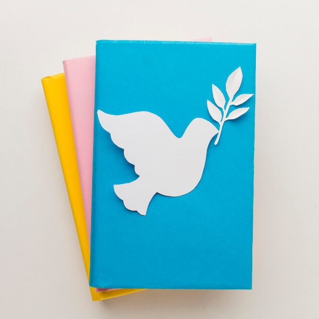 Free photo top view of paper dove on books