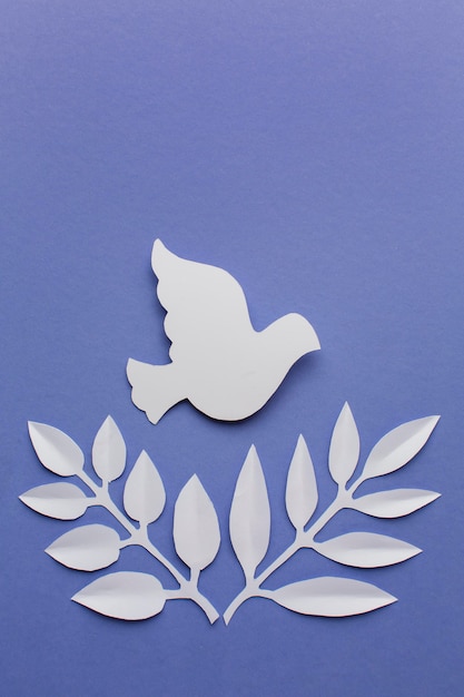 top view of paper dove with leaves and copy space