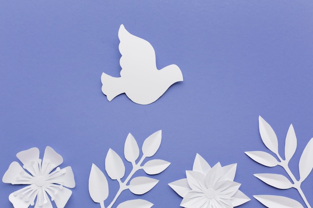 Top view of paper dove with leaves