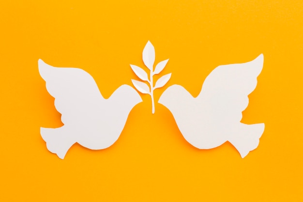 Top view of paper doves with leaves