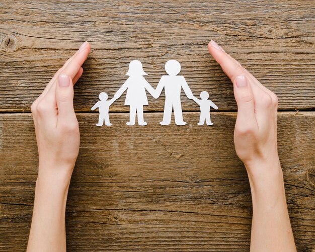 Top view paper family composition on wooden background