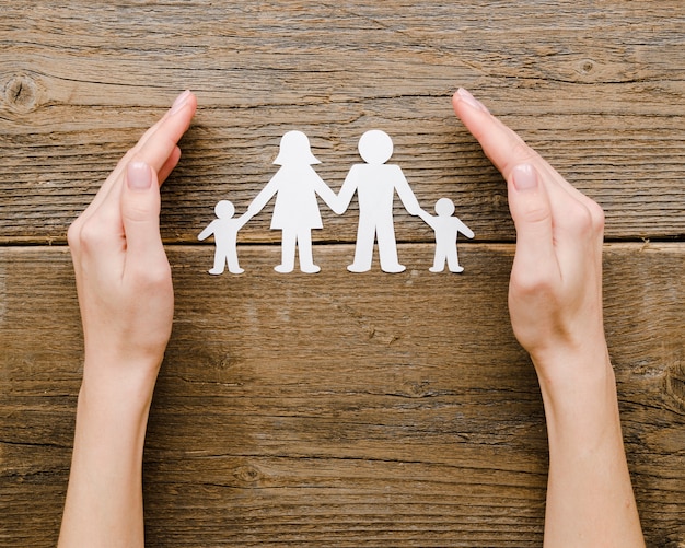 Top view paper family composition on wooden background