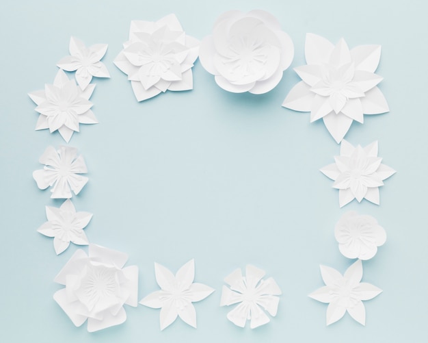 Free photo top view paper flowers frame on table