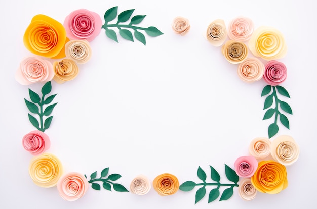 Top view paper flowers and leaves on white background