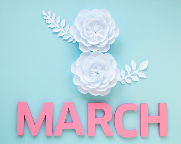 Top view of paper flowers with month for women's day