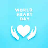 Free photo top view of paper heart and hands for world heart day
