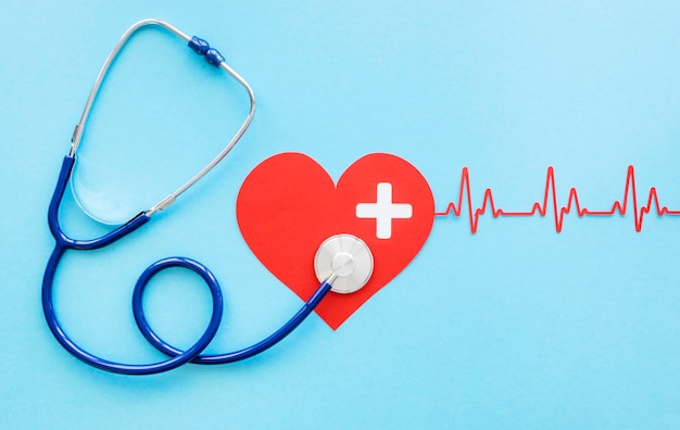 Top view of paper heart with heartbeat and stethoscope for heart day