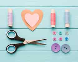 Free photo top view of paper heart with sewing supplies for valentines day