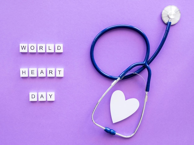 Free photo top view of paper heart with stethoscope