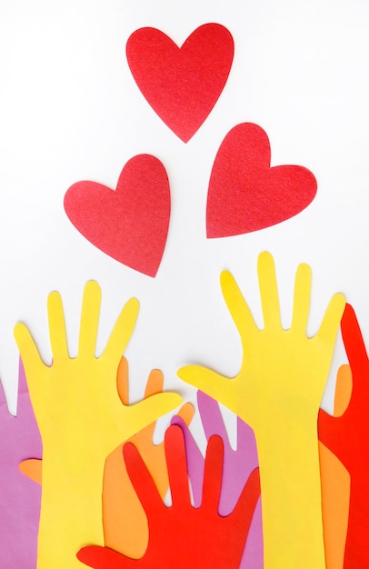 Top view of paper hearts with hands