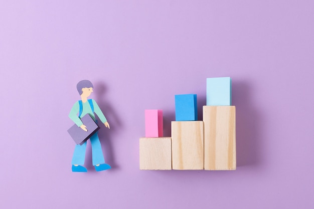 Top view paper man with wooden pieces