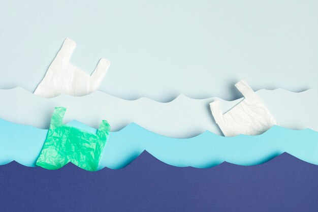 Top view of paper ocean waves with plastic bags