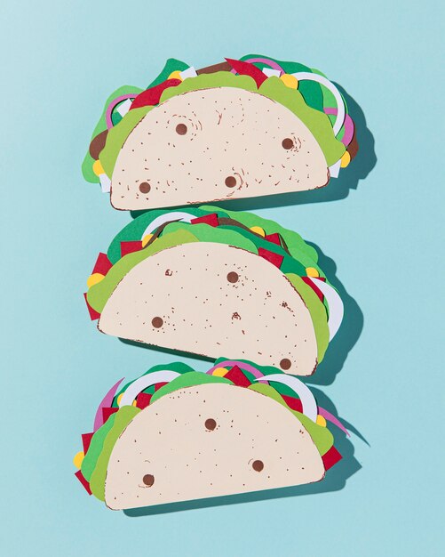 Top view paper tacos on blue background