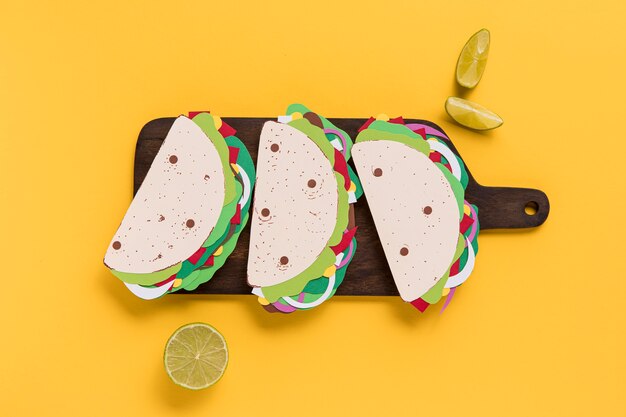 Top view paper tacos on wooden board