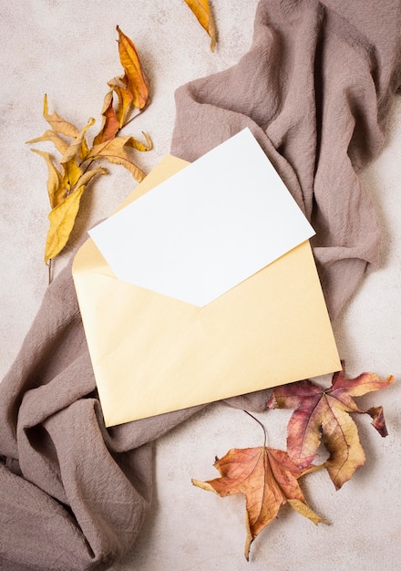 Top view of paper with envelope and leaves