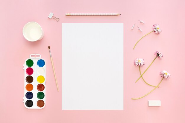 Top view of paper with flowers and palette