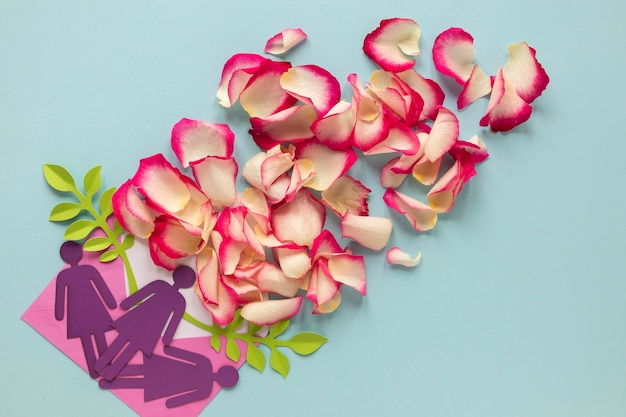 Top view of paper women with petals for women's day