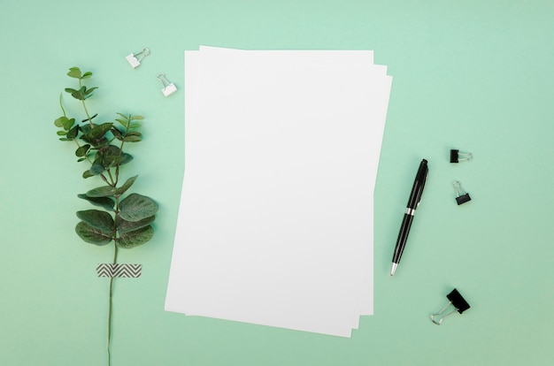 Top view of papers on desk with pen and paper clips