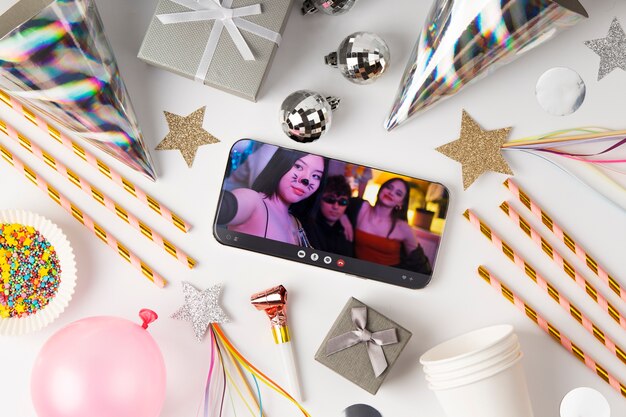 Top view party decorations with smartphone