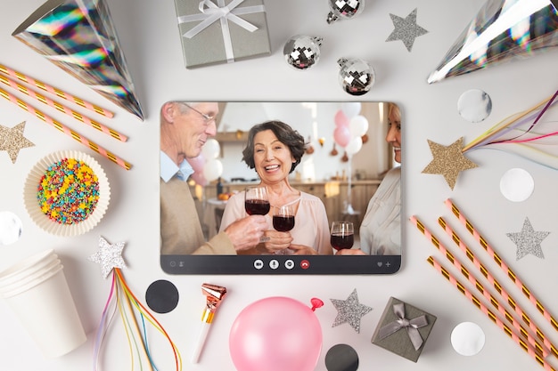 Free photo top view party decorations with tablet