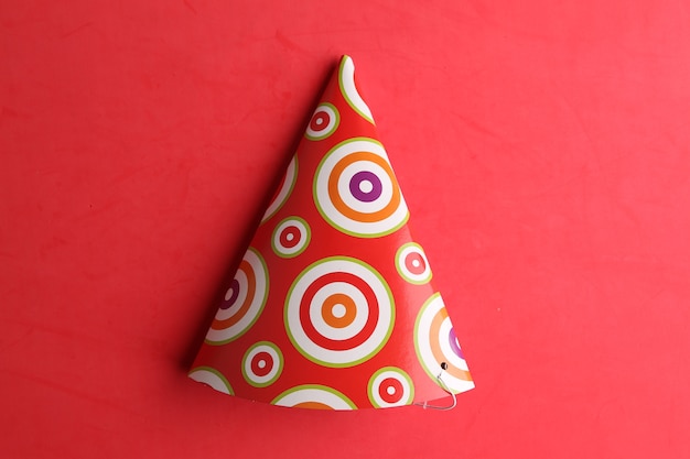 Top view of a party hat isolated on a red background