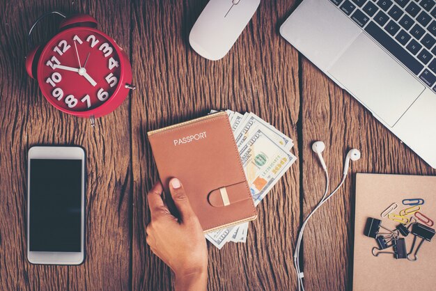 Top view passport with money on workspace, tourism concept