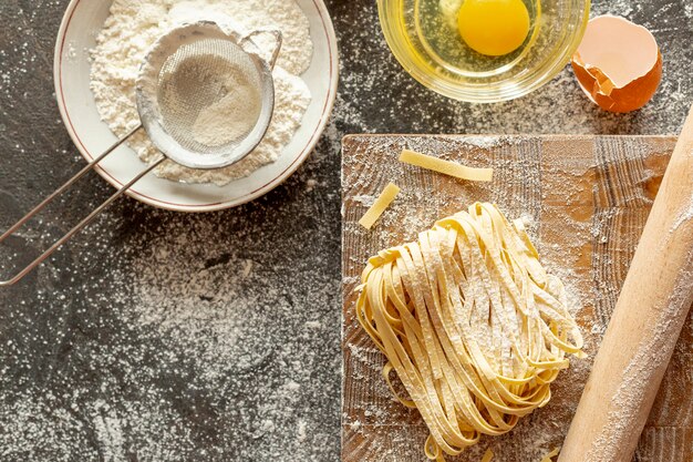 Top view of pasta ingredients and chopper