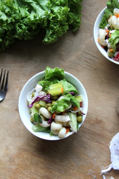 Top view pasta salad with salad leaves