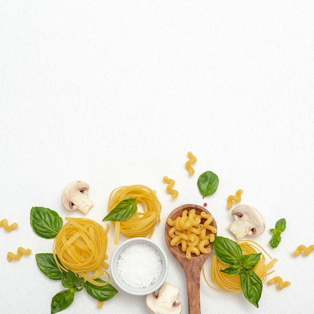 Free photo top view of pasta and salt on plain background with copy space