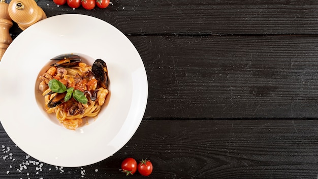 Top view of pasta and seafood on wooden table