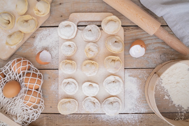 Top view pasta with filling and flour sprinkled