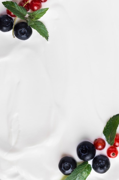 Top view paste white natural yogurt and berries