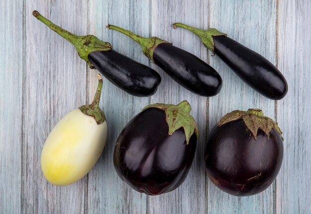 Top view of pattern of eggplants on wooden background