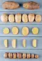 Free photo top view of pattern of whole and sliced potato on wooden background
