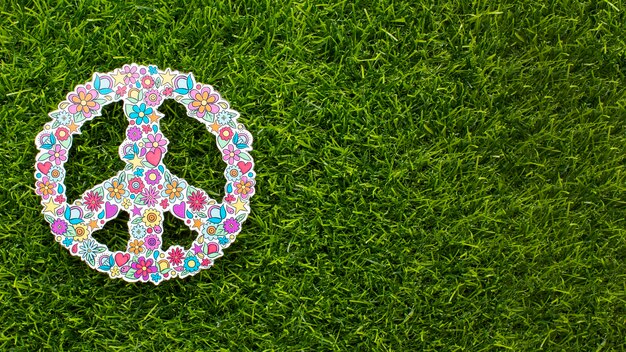 Top view of peace sign on grass with copy space