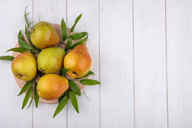 Top view of peaches on cutting board and wooden surface