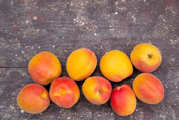 A top view  peaches mellow and juicy on the wooden desk fruit summer photo pulp