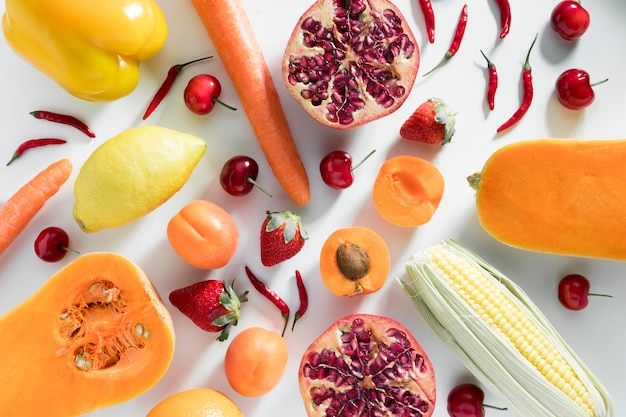 Top view of peaches with corn and pomegranate