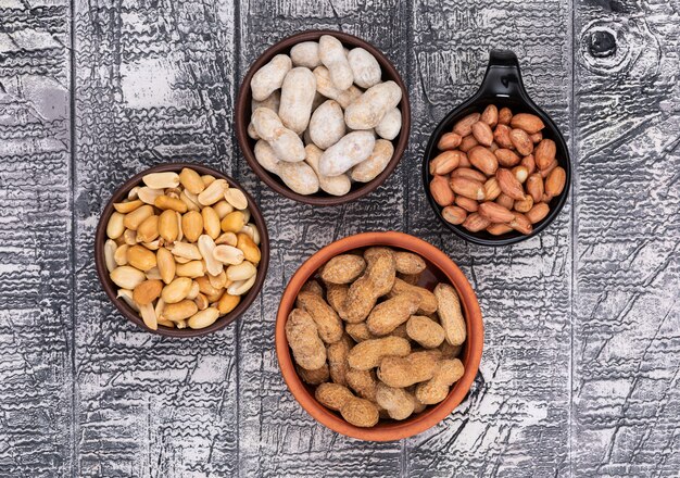 Top view peanuts in bowls on wooden 