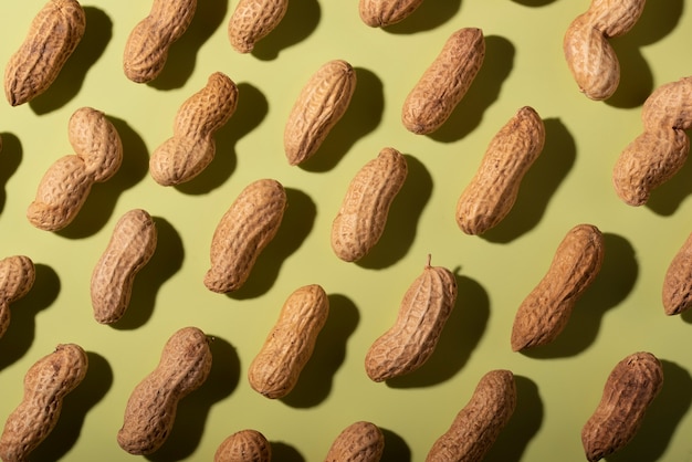 Top view peanuts on green background