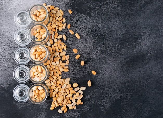 Top view peanuts in jars with copy space on stone  horizontal