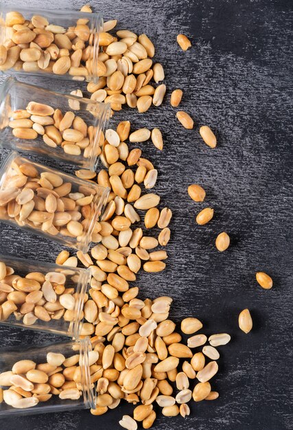 Top view peanuts in jars with copy space on stone  vertical